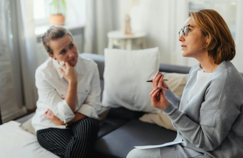 A South Asian client speaking with a counsellor in a calm office