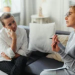 A client speaking with a counsellor in a calm office
