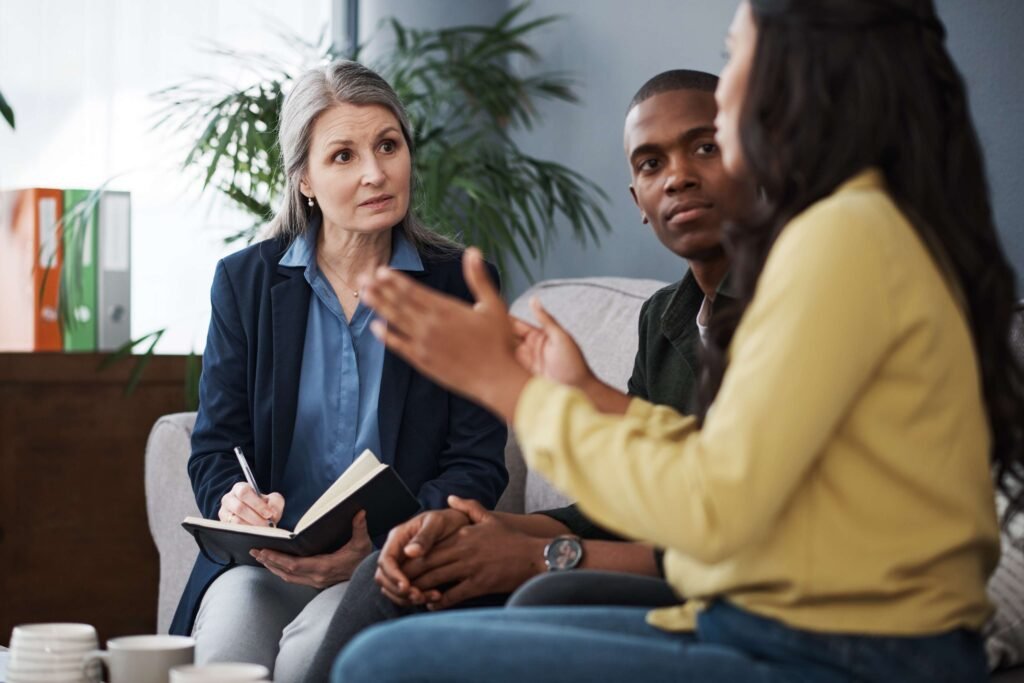 A couple talking with a therapist during a couples counselling session
