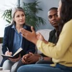 A couple talking with a therapist during a couples counselling session