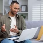 A man checking his benefits coverage online on a laptop before booking counselling