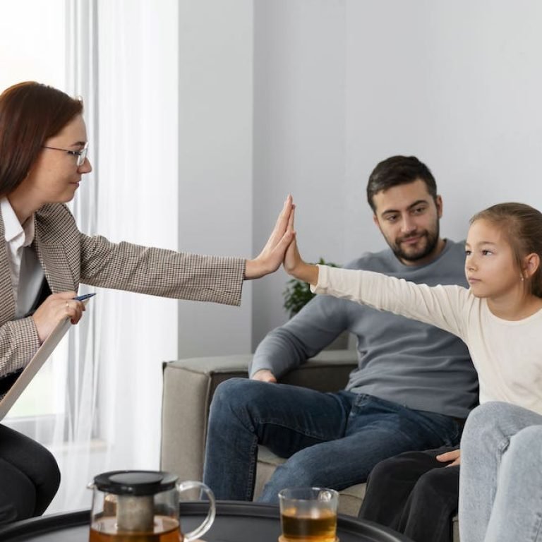 A South Asian family talking together in a family therapy session