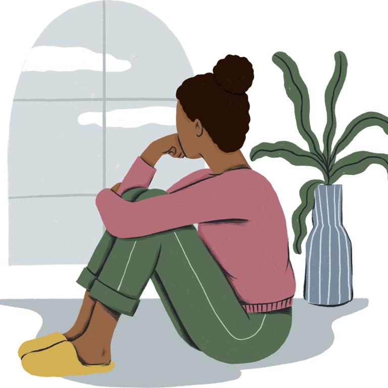 A woman looking out a window, feeling lonely