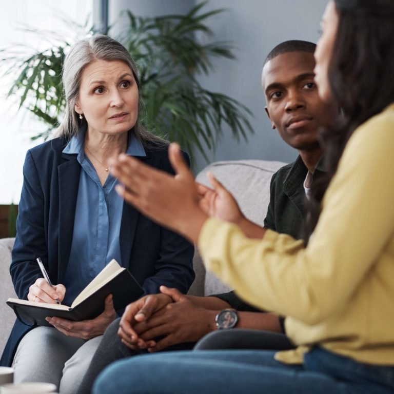 A couple talking with a therapist during a couples counselling session