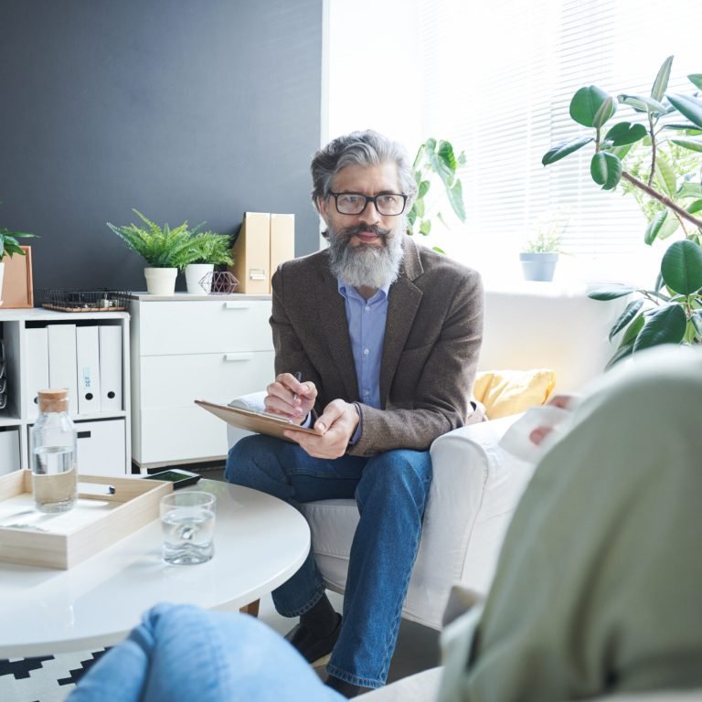 A counsellor listening to a client during a first counselling session